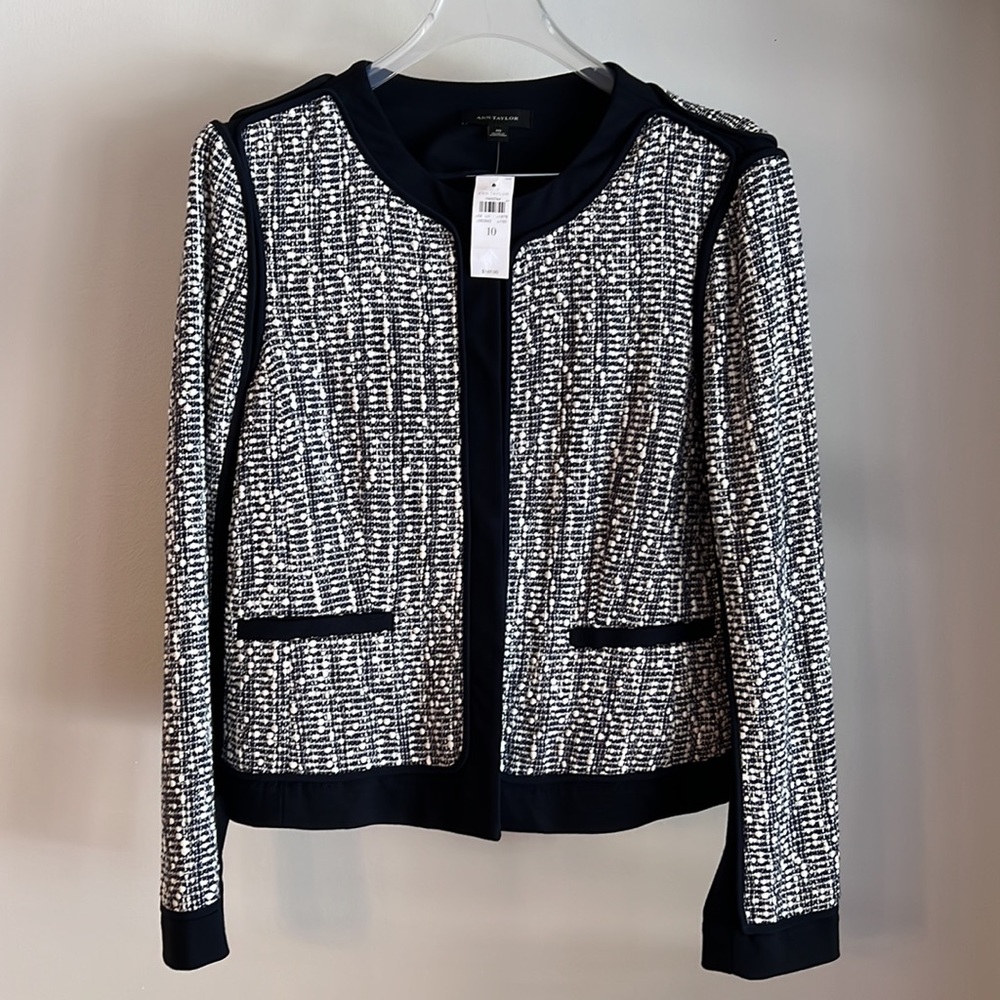 And Taylor navy suit with ivory tweed. Jacket size 10  skirt size 8.